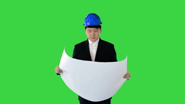 Architect Looking at Blueprint While Walking and Looking Around on a Green Screen Chroma Key