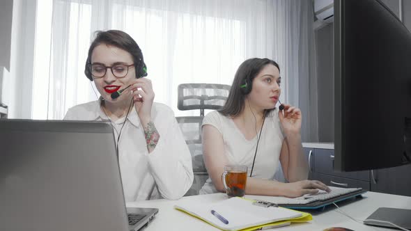 Two Female Call Center Agents Working on Their Computers