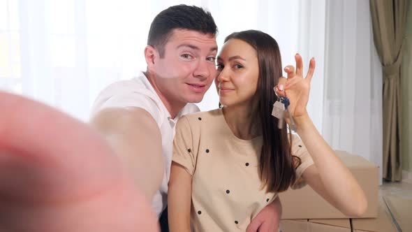 Happy Couple Makes Selfie with Keys to Amazing New House