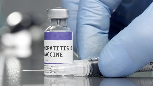 Hepatitis B vaccine vial in medical lab with syringe