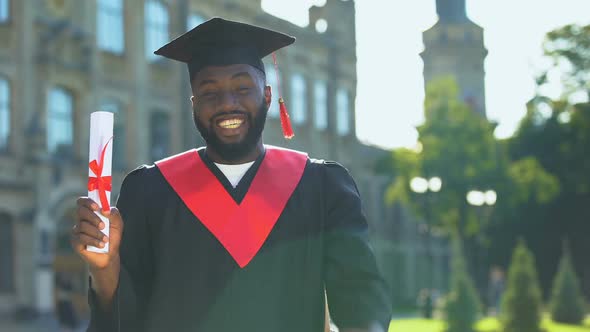 Glad Graduating Student Showing Yes Gesture Holding Diploma University Education