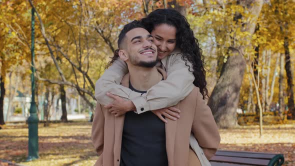 Close Up Portrait Guy Holding Piggyback Female Outdoors Romantic Date in Autumn Park Family Have Fun