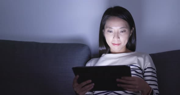 Woman use of tablet computer at night 