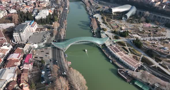 Aerial view of Tbilisi city central park and Bridge of Peace. Beautiful morning cityscape of Tbilisi