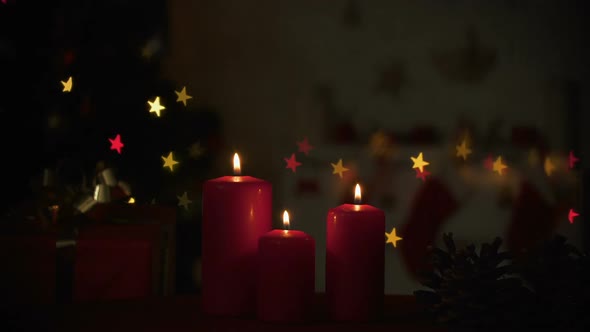 Candles Burning Near Sparkling Christmas Decorations, Cozy Holiday Atmosphere