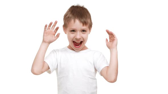 Elementaryschool Aged Caucasian Boy Making Faces and Kidding Around Standing on White Background in