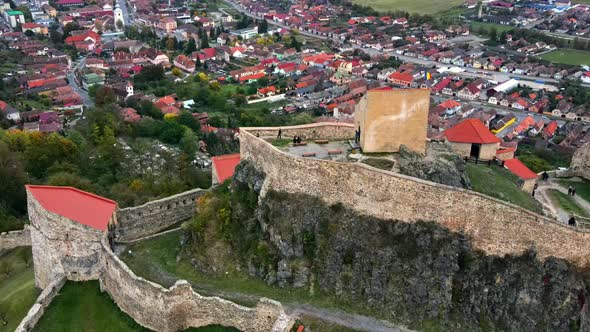 Aerial drone view of Rupea Fortress, Romania. Citadel located on a cliff, tourists, town