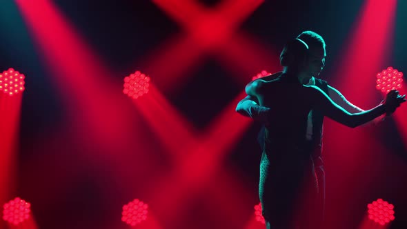 Graceful Argentine Tango Among Smoke and Bright Red Neon Lights in a Dark Studio