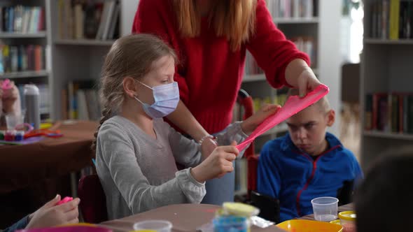 Masked Teacher and Girl Stretching Slime in Class