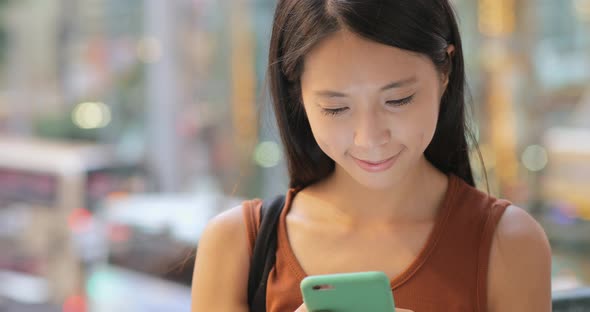 Woman use of mobile phone at outdoor street 