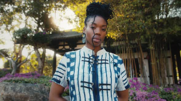 Stylish AfricanAmerican Woman in Fashionable Clothes Standing in Front of a Chinese Building