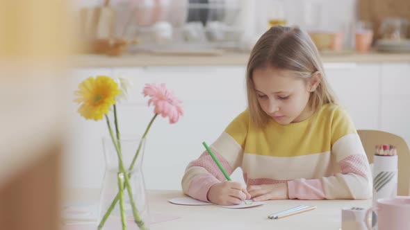 Kid Drawing Using Coloured Pencils