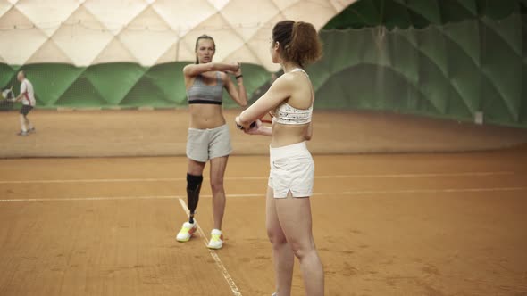 A Beautiful Athletic Invalid Girl Teaches the Beginner of the Correct Trajectory of a Racket Hit in