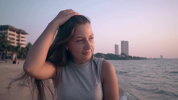 Brunette Woman Touches Long Hair on Sea Coast Slow Motion