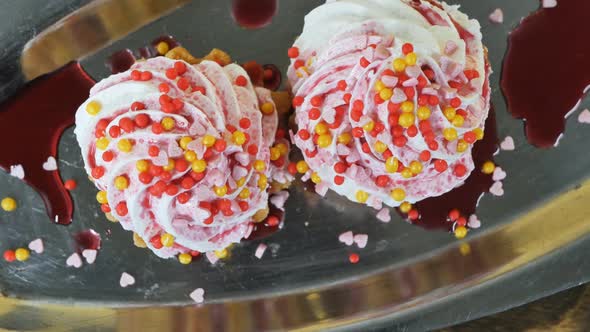 Top View of Two Cakes with Cream and Colorful Decorations Round Balls