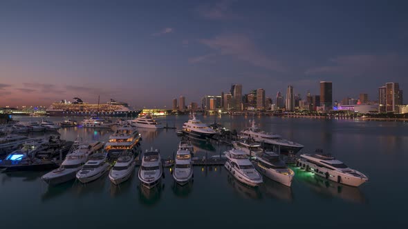 Miami skyline with yacht club in night-to-day time lapse