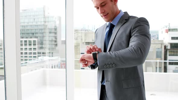 Handsome Businessman Sing his Smart Watch