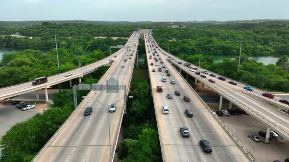 Traffic in in Austin Texas. Interstate highway pullback view of fast moving cars and trucks on freew