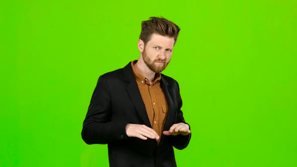 Man Watches a Movie and Punches His Finger Down. Green Screen