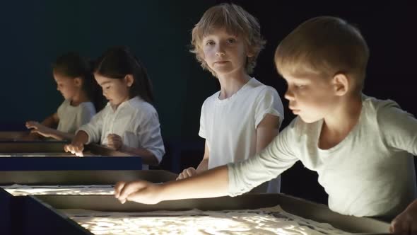 Cute Boy Smiling in Sand Animation Class