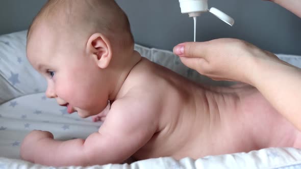 Mother Giving Back Massage To Little Child