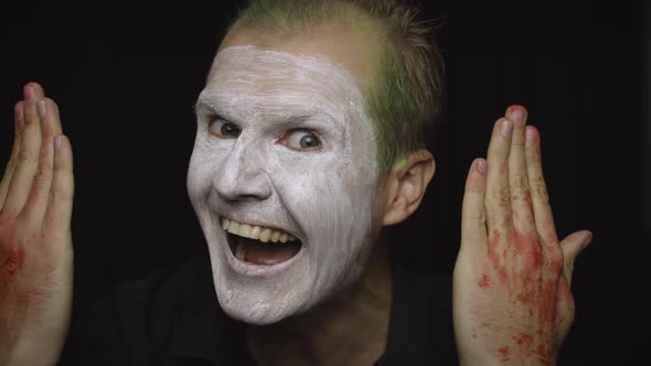 Clown Halloween Man Portrait. Close-up of an Evil Clowns Face. White Face Makeup