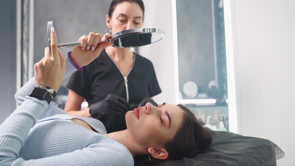 Permanent Makeup Master Prepares Woman Client for Eyebrow Microblading Procedure