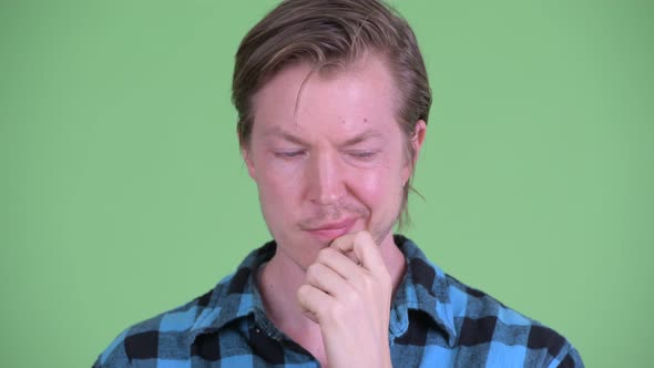 Face of Stressed Young Hipster Man Thinking and Looking Down