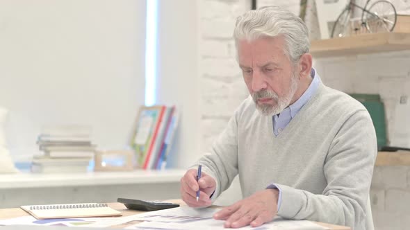 Old Man Working on Documents at Work