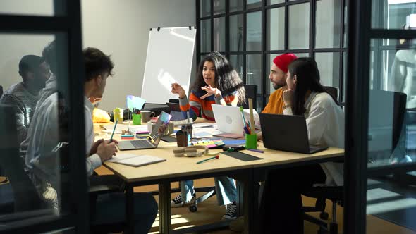 Multiracial Coworkers Sharing Ideas at Meeting