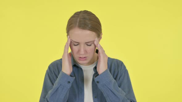 Young Woman Having Headache on Yellow Background