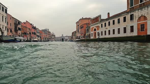 Low angle water surface pov of Venice seen from stern ofing navigating ferry boat , Venice in Italy
