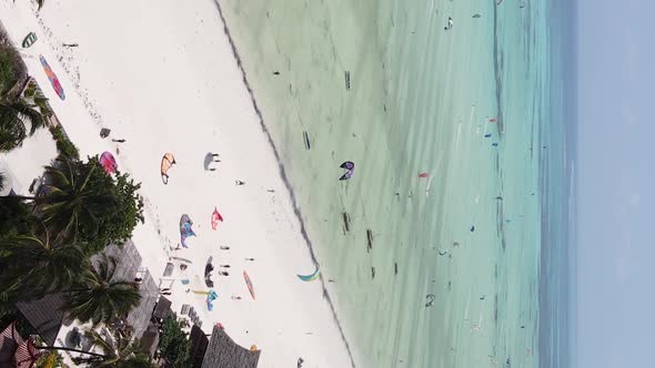 Vertical Video Kitesurfing Near the Shore of Zanzibar Tanzania Aerial View