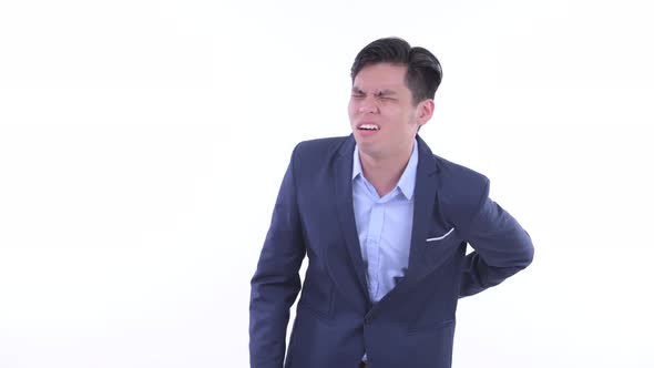 Stressed Young Asian Businessman Having Back Pain