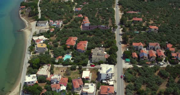 Aerial cable pan up from Skala Sotiros town to reveal beautiful mountains on the island of Thassos,