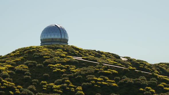A modern astronomical observatory in a vast meadow valley during a day. 4KHD