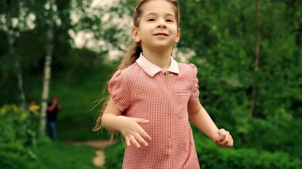 Cheerful Family Having Fun In Park. Girl Running To Parents. Children Enjoy Playing Funny Activity.