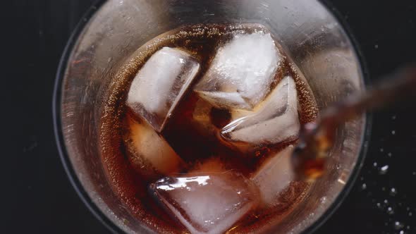 Stream of Cooling Drink Falls Into the Glass Slow Motion