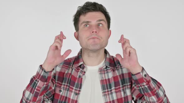 Portrait of Young Man Praying with Fingers Crossed