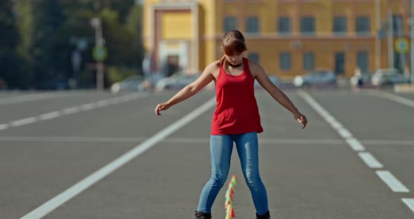 Teenager Girl Turns Around on Roller Skates Spins