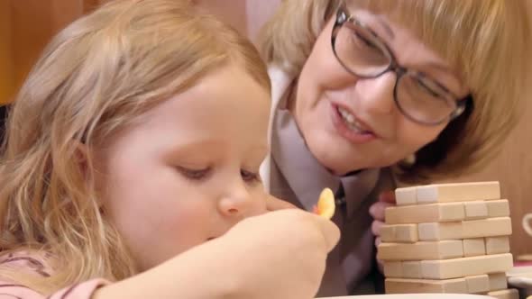 Little Cutie Eating Pizza at Dinner with Grandma