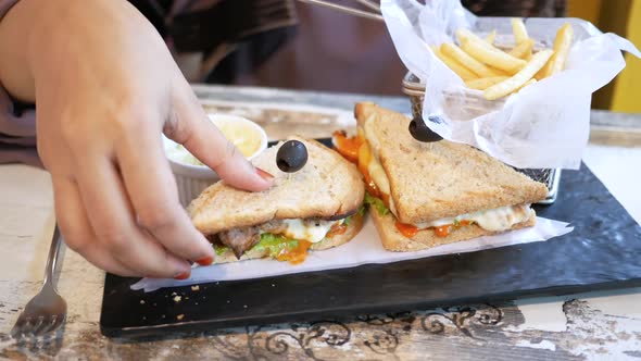 Slice of Beef Sandwich and Chips on Plate on Table