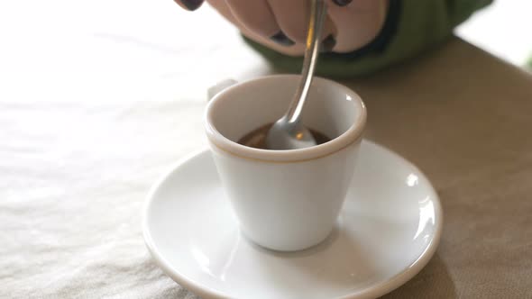 Mixing the Sugar in The Espresso- Close Up