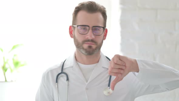 Portrait of Doctor Showing Thumbs Down Gesture