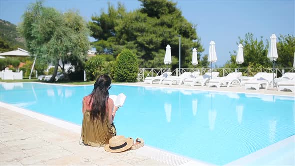 Woman Relaxing By the Pool in a Luxury Hotel Resort Enjoying Perfect Beach Holiday Vacation