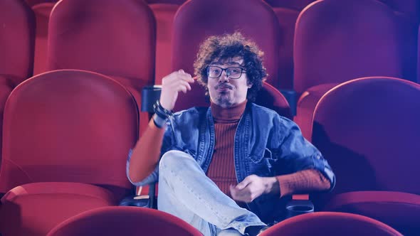 Cinema Hall with a Man Laughing Hard at the Movie