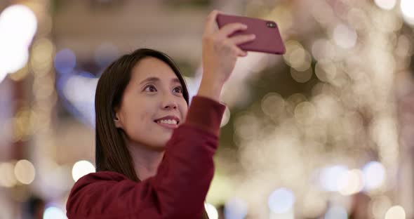 Woman Take Photo on Christmas Tree Decoration at Night