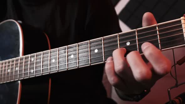 Young Man Playing Acoustic Guitar While Sitting Sofa Home Recording Studio