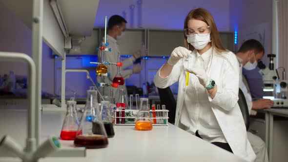 Young Scientist Mixing Colored Liquids