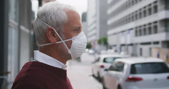 Caucasian man out and about in the street wearing on a face mask against coronavirus